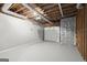 Unfinished basement area with exposed ceiling and a white garage door, offering potential for customization at 3328 Sulky Se Cir, Marietta, GA 30067
