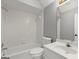 Full bathroom with tub, toilet, vanity, and decorative mirror at 3328 Sulky Se Cir, Marietta, GA 30067