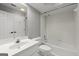 White bathroom features a shower-tub combo, single sink vanity and tile flooring at 3328 Sulky Se Cir, Marietta, GA 30067