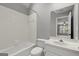 Clean bathroom featuring white tile, a tub with shower, and a modern sink with a large mirror at 3328 Sulky Se Cir, Marietta, GA 30067