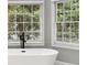 Modern bathroom with standalone tub near window with natural light at 3328 Sulky Se Cir, Marietta, GA 30067