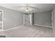 Spacious carpeted bedroom with neutral walls, ceiling fan, closet, and attached bath at 3328 Sulky Se Cir, Marietta, GA 30067
