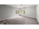 Neutral carpeted bedroom with a ceiling fan and two windows offering ample natural light at 3328 Sulky Se Cir, Marietta, GA 30067
