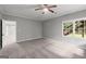 Neutral carpeted bedroom with a window and trim plus ceiling fan at 3328 Sulky Se Cir, Marietta, GA 30067