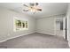 Spacious bedroom features neutral walls, carpet, ceiling fan, and a window offering natural light at 3328 Sulky Se Cir, Marietta, GA 30067