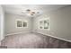 Large carpeted bedroom with two windows and a ceiling fan offering ample natural light at 3328 Sulky Se Cir, Marietta, GA 30067