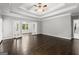 Bright bedroom with dark hardwood floors, ceiling fan, and double doors leading to another room at 3328 Sulky Se Cir, Marietta, GA 30067