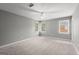 Bright, carpeted bedroom with three windows, ceiling fan and neutral colored walls at 3328 Sulky Se Cir, Marietta, GA 30067