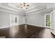 Spacious bedroom with tray ceiling, hardwood floors, and natural light from windows at 3328 Sulky Se Cir, Marietta, GA 30067