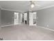 Spacious bedroom with multiple entryways, neutral carpet, and a ceiling fan at 3328 Sulky Se Cir, Marietta, GA 30067