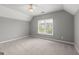 Carpeted bedroom with window, ceiling fan, and neutral paint at 3328 Sulky Se Cir, Marietta, GA 30067