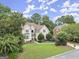Beautiful home showcasing a well-manicured lawn and mature trees surrounded by lush green landscaping at 3328 Sulky Se Cir, Marietta, GA 30067