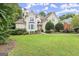 Lovely home with a large lawn, mature trees, and a welcoming entrance with stone steps at 3328 Sulky Se Cir, Marietta, GA 30067