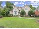 Attractive home with manicured lawn, mature trees, and a charming front entrance with stone steps at 3328 Sulky Se Cir, Marietta, GA 30067