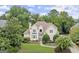 Beautiful home exterior with mature trees, well-manicured lawn, and a circular driveway at 3328 Sulky Se Cir, Marietta, GA 30067