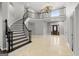 Bright foyer boasts a winding staircase, elegant chandelier, and dark wood front door at 3328 Sulky Se Cir, Marietta, GA 30067