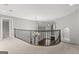 Hallway with a curved banister overlooking the foyer and a view of the living room with a fireplace at 3328 Sulky Se Cir, Marietta, GA 30067