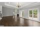 A large living room with hardwood floors, many windows, a fireplace, and a beautiful chandelier at 3328 Sulky Se Cir, Marietta, GA 30067