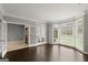 Bright living room with hardwood floors, open doorway, and natural light from bay windows at 3328 Sulky Se Cir, Marietta, GA 30067