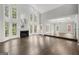 Open living room showcasing the fireplace, tall windows, and wood floors at 3328 Sulky Se Cir, Marietta, GA 30067