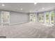Spacious living room with neutral carpet, recessed lighting, and double glass doors leading to the outside at 3328 Sulky Se Cir, Marietta, GA 30067