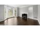 Bright living room featuring hardwood floors, a fireplace, and a large bay window at 3328 Sulky Se Cir, Marietta, GA 30067