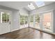 Cozy sunroom with hardwood floors, skylights, and views to the backyard at 3328 Sulky Se Cir, Marietta, GA 30067
