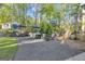 Spacious backyard featuring a patio with grilling area, seating under umbrellas, and lush greenery at 11 Frances Turn, Sharpsburg, GA 30277