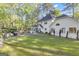 Expansive backyard with outdoor kitchen and seating, a screened porch, and a lush green lawn at 11 Frances Turn, Sharpsburg, GA 30277