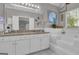 Bright bathroom boasts a dual sink vanity, granite countertops, and a separate soaking tub at 11 Frances Turn, Sharpsburg, GA 30277