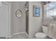 Clean bathroom featuring a glass door walk-in shower, tile floor, and modern toilet at 11 Frances Turn, Sharpsburg, GA 30277