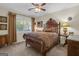Cozy bedroom with a wooden bed frame, carpet, and a window providing ample natural light at 11 Frances Turn, Sharpsburg, GA 30277