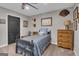 Themed bedroom featuring neutral tones, interesting art, and comfortable single bed at 11 Frances Turn, Sharpsburg, GA 30277
