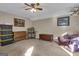 Carpeted bonus room featuring bright light, comfortable seating, and decorative wall art at 11 Frances Turn, Sharpsburg, GA 30277