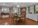 Cozy dining room with wood floors, a round table with chairs, and natural light from the windows at 11 Frances Turn, Sharpsburg, GA 30277