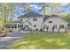 Spacious white home with screened porch, patio area, and meticulously maintained lawn, nestled in a serene setting at 11 Frances Turn, Sharpsburg, GA 30277