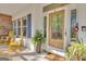 Inviting front porch area with rocking chairs and decorative plants that add character to the entrance at 11 Frances Turn, Sharpsburg, GA 30277