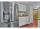 Well-lit kitchen featuring stainless steel refrigerator and white cabinets at 11 Frances Turn, Sharpsburg, GA 30277