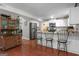 Bright, open kitchen featuring white cabinets, granite countertops, and stainless steel appliances at 11 Frances Turn, Sharpsburg, GA 30277