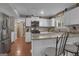 Bright kitchen featuring white cabinets, granite countertops, and a stainless steel refrigerator at 11 Frances Turn, Sharpsburg, GA 30277