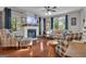Cozy living room featuring a fireplace, hardwood floors, and comfortable seating with natural light at 11 Frances Turn, Sharpsburg, GA 30277