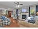Open-concept living room featuring a fireplace, hardwood floors, and ample space for furniture at 11 Frances Turn, Sharpsburg, GA 30277