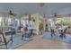 Spacious screened porch with multiple seating areas, ceiling fans, and outdoor views at 11 Frances Turn, Sharpsburg, GA 30277