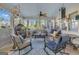 Bright and spacious screened porch with diverse seating arrangements, ceiling fans, and cozy decor at 11 Frances Turn, Sharpsburg, GA 30277