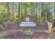 Welcoming community entrance sign to Le Paradis, featuring lush foliage at 11 Frances Turn, Sharpsburg, GA 30277