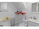 Clean bathroom with a toilet, sink, vanity and red shelf at 5141 Dixie Lake Rd, Union City, GA 30291
