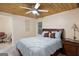 Comfortable bedroom with a wood ceiling, large bed, neutral walls and tile floor at 5141 Dixie Lake Rd, Union City, GA 30291