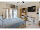 Bedroom featuring a ceiling fan, mounted television, window and neutral colors at 5141 Dixie Lake Rd, Union City, GA 30291