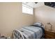 Small bedroom featuring a metal frame bed, window, and side table with a drawer unit at 5141 Dixie Lake Rd, Union City, GA 30291
