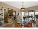 Dining room featuring glass table, seating for six, hardwood floors, and natural light at 5141 Dixie Lake Rd, Union City, GA 30291